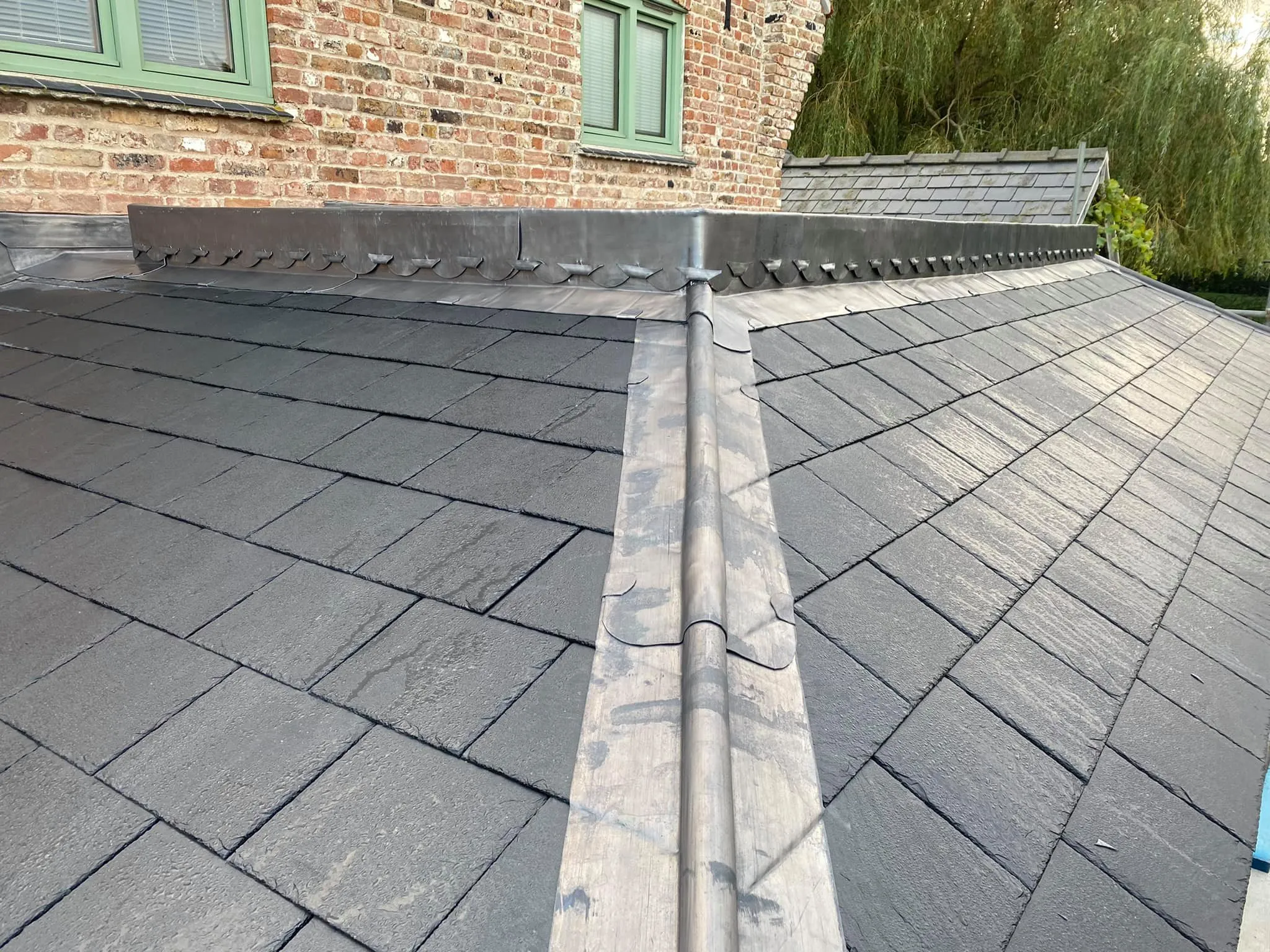Close detail of a lead roll running down a slate roof